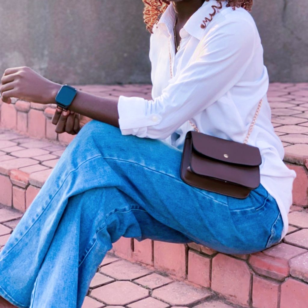 Small leather crossbody bag style with jeans and white top