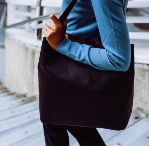 "Slouchy hobo bag draped over a shoulder in soft leather